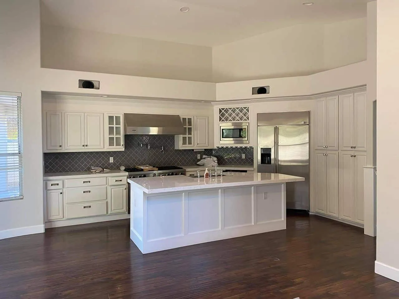 Open kitchen with freshly painted white cabinets and walls